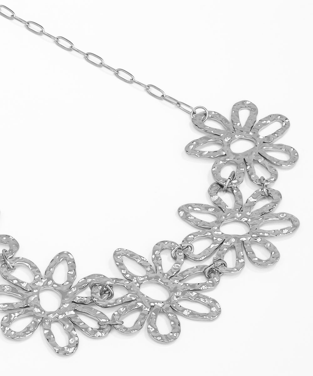 Silver floral necklace on a white background