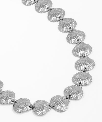 Silver necklace with textured shell-like beads on a white background
