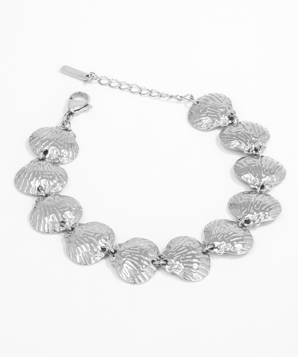 Silver shell bracelet on a white background