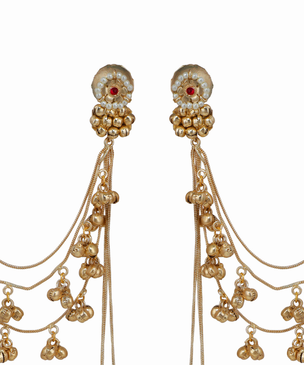 Gold earrings with intricate designs on a white background