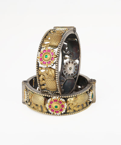 Decorative bracelets with floral and elephant designs on a white background