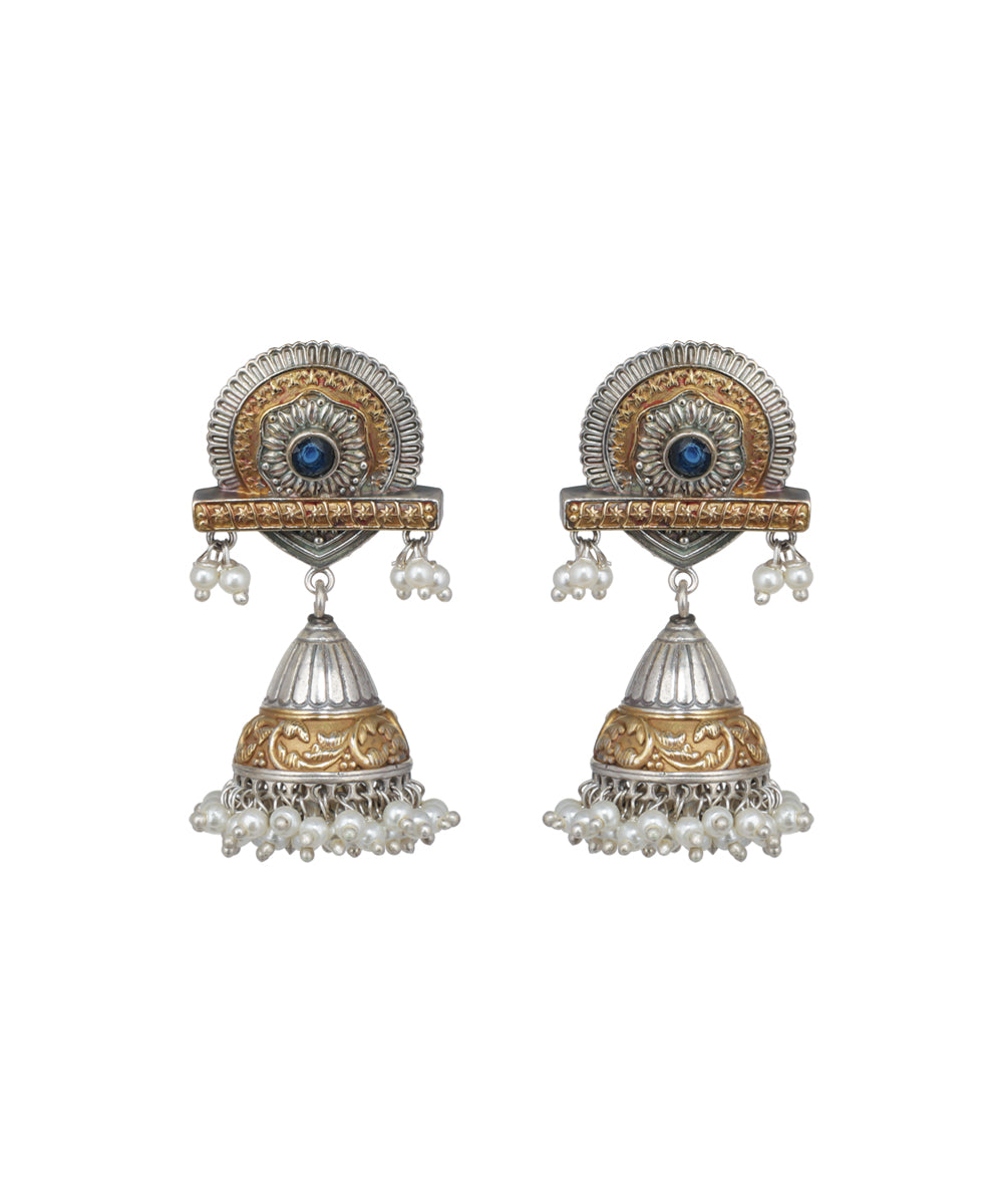 Pair of ornate earrings with gold and silver design on a white background