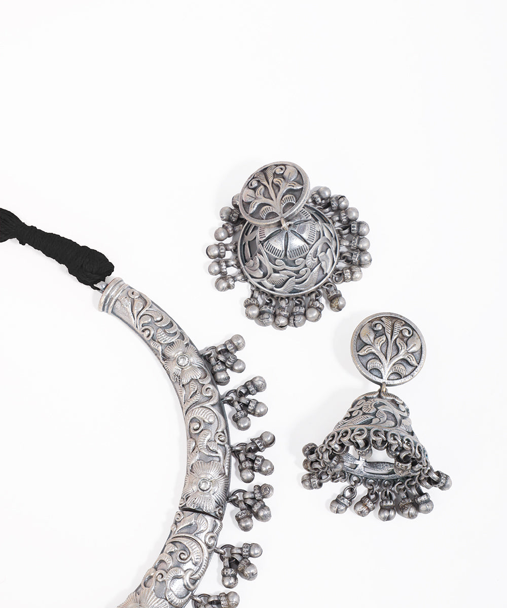 Silver jewelry set with necklace and earrings on a white background