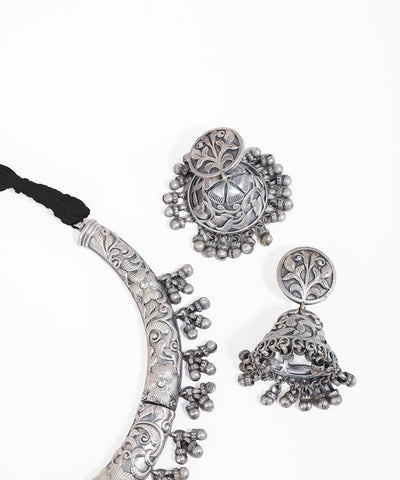 Silver jewelry set with necklace and earrings on a white background