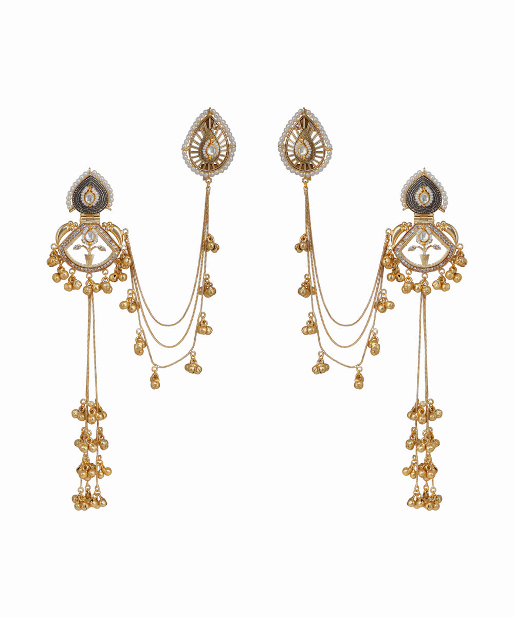 Pair of gold earrings with intricate designs on a white background