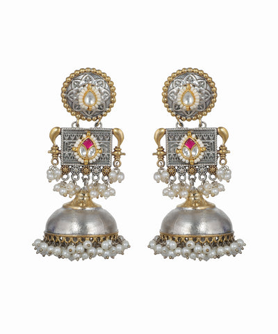 Pair of ornate earrings with pearls and gemstones on a white background