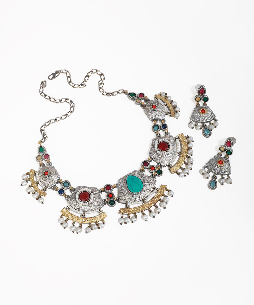 Ornate necklace with colorful stones on a white background