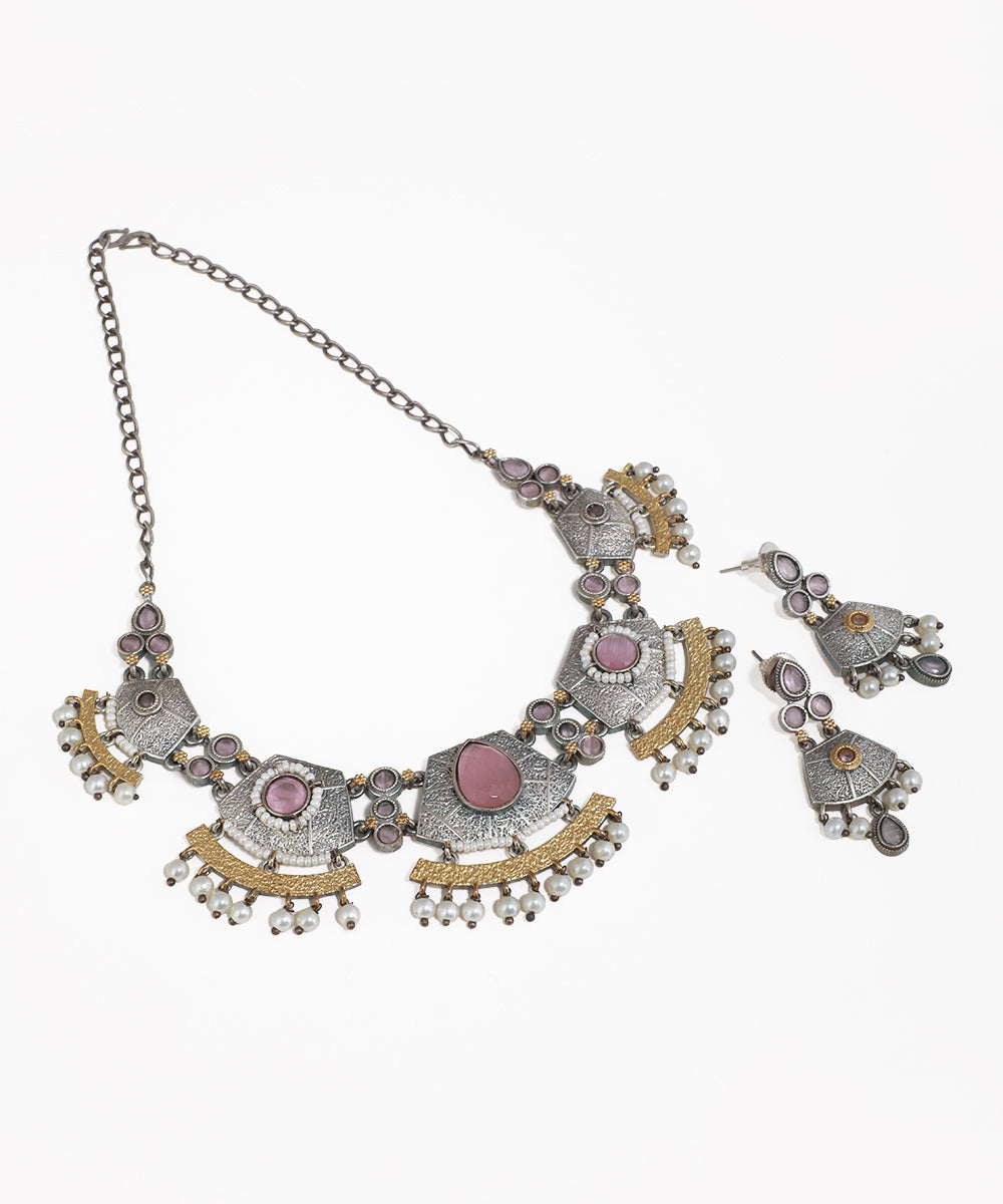 Ornate necklace with pink stones on a white background