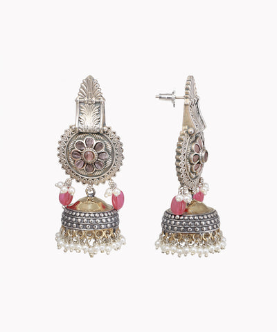 Pair of silver and pink earrings on a white background