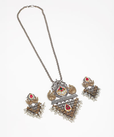Oxidised silver-tone necklace set with peacock motifs, red and green stones, and faux pearls.