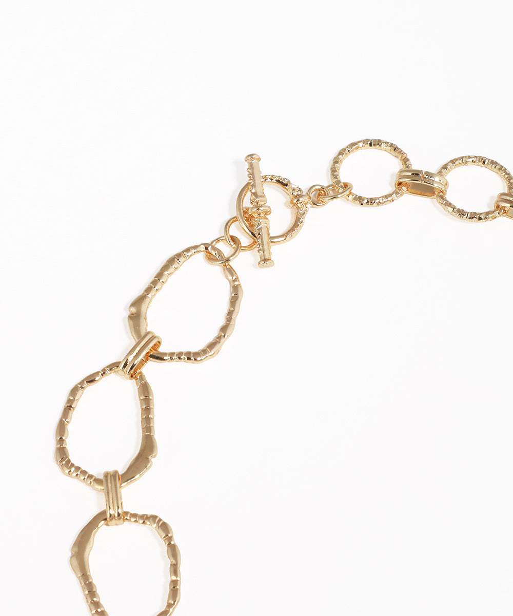 Gold chain bracelet on a white background
