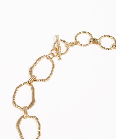 Gold chain bracelet on a white background