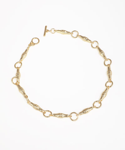 Gold-tone necklace with chunky bamboo-shaped links and a front toggle closure