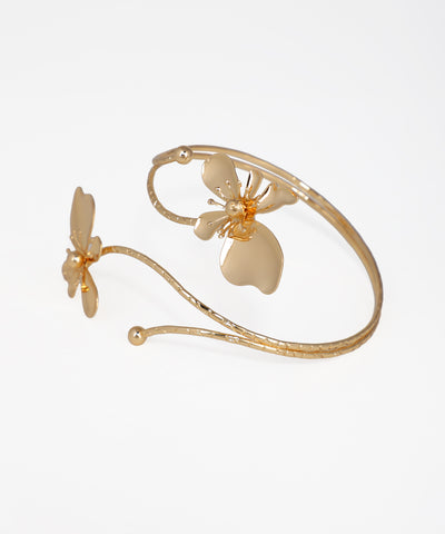 Gold bracelet with butterfly designs on a white background