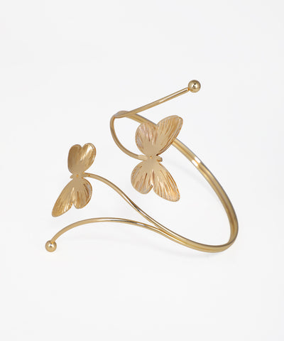 Gold butterfly-shaped cuff bracelet on a white background