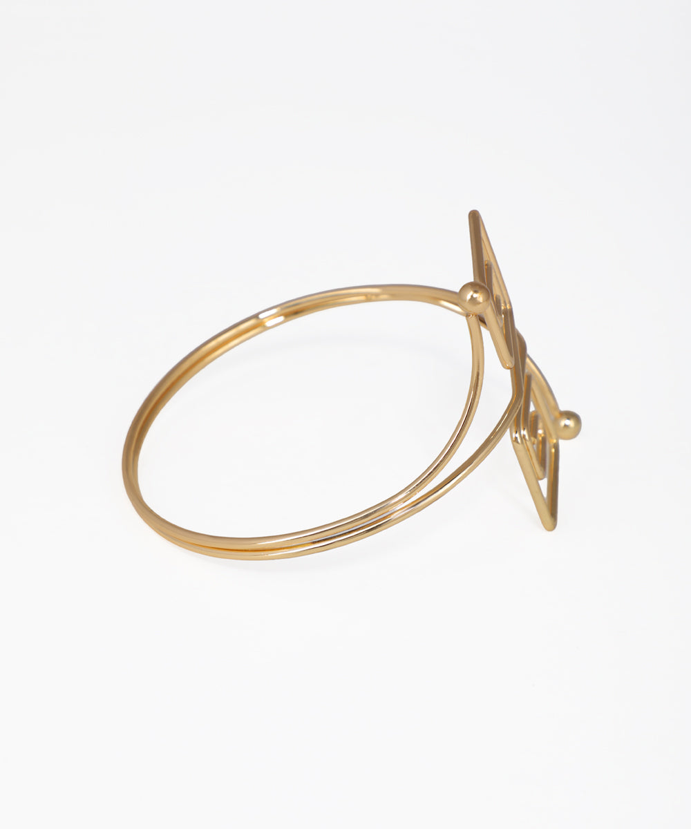 Gold ring with a bow design on a white background