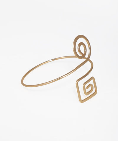 Gold ring with a geometric design on a white background