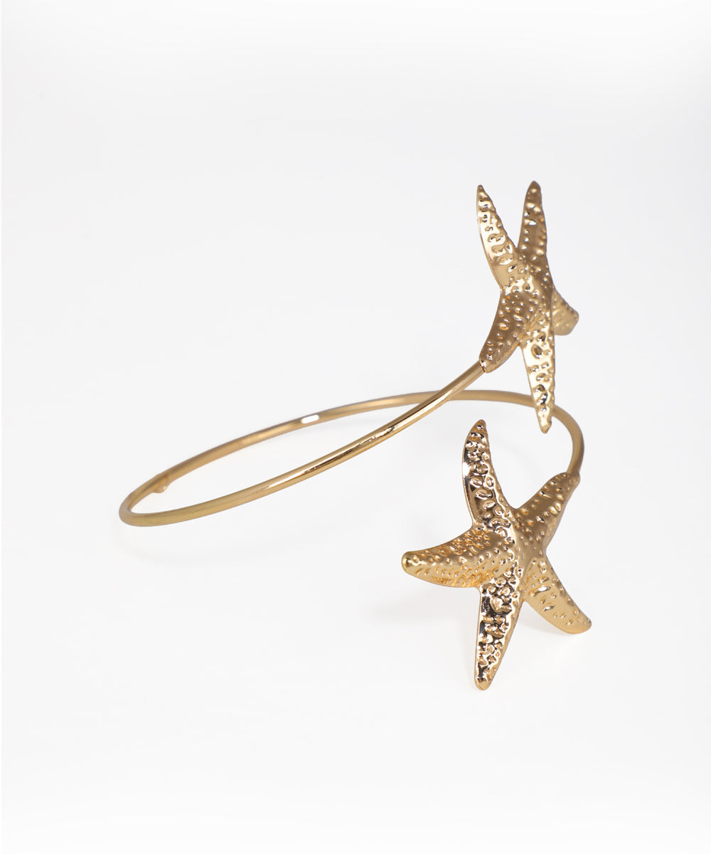 Gold starfish bracelet on a white background