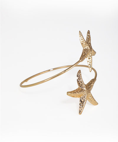 Gold starfish bracelet on a white background