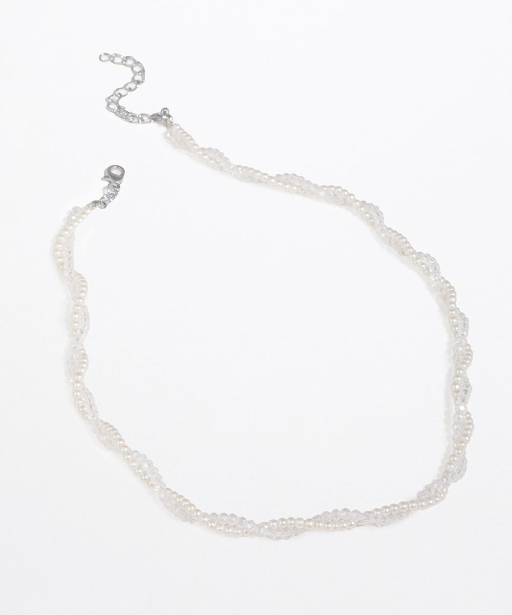 Silver-tone necklace with intertwined strands of faux pearls and clear faceted beads, featuring an adjustable chain.