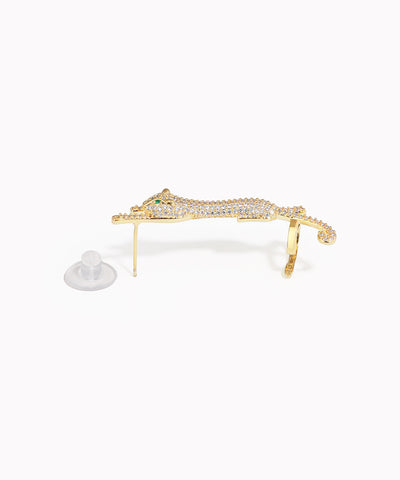 Gold bracelet with clear stones on a white background