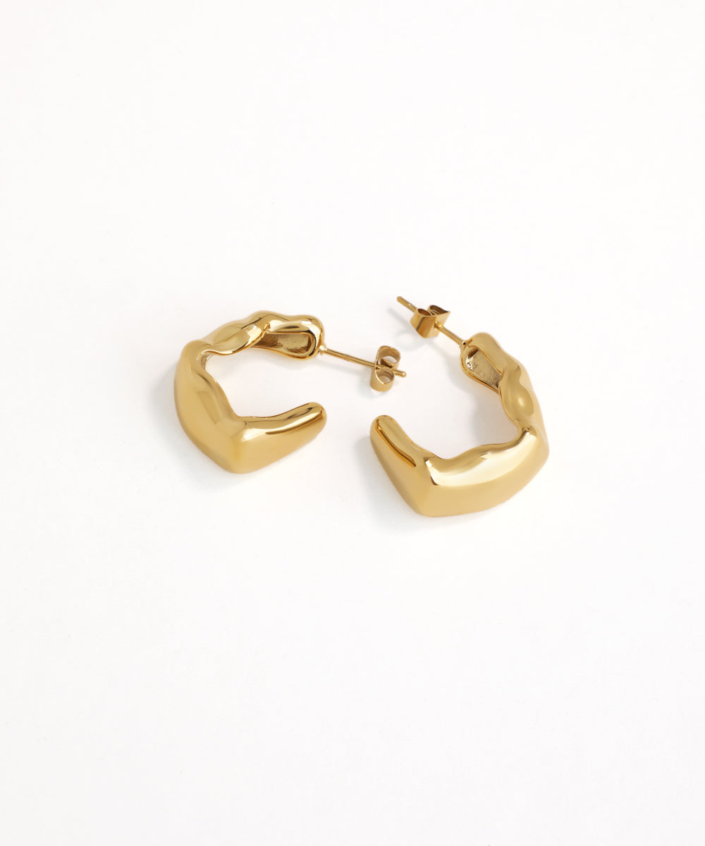 Gold hoop earrings on a white background