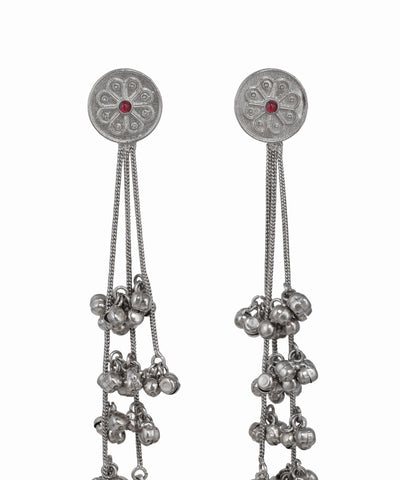 Pair of silver earrings with dangling beads on a white background