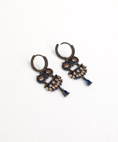 Pair of ornate earrings with blue and gold accents on a white background