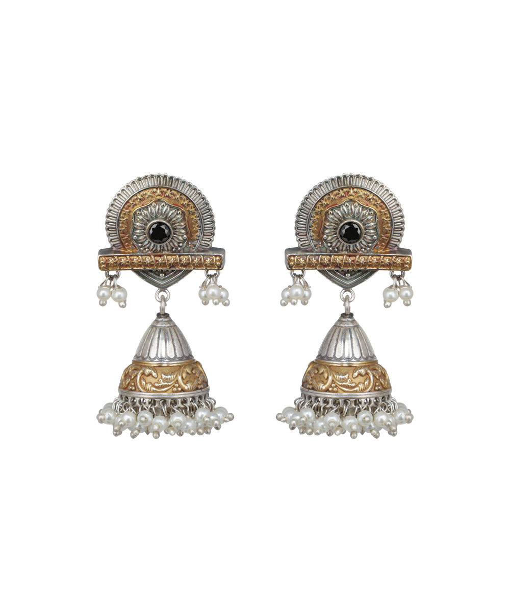 Pair of ornate earrings with intricate designs on a white background