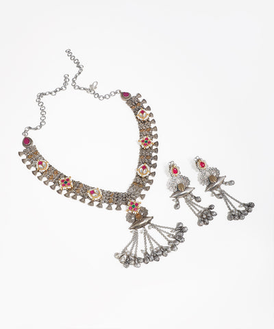 Oxidised silver-tone necklace set with floral motifs, colored stones, faux pearls, and ghungroo drops.