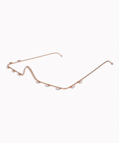 Rose-gold-tone facelet with wavy contour design and small clear stone embellishments.