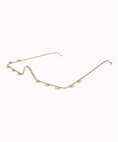 Gold eyeglass frame with small pearls on a white background