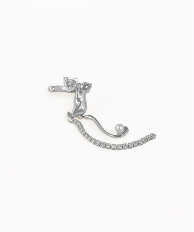Silver earring with clear gemstones on a white background