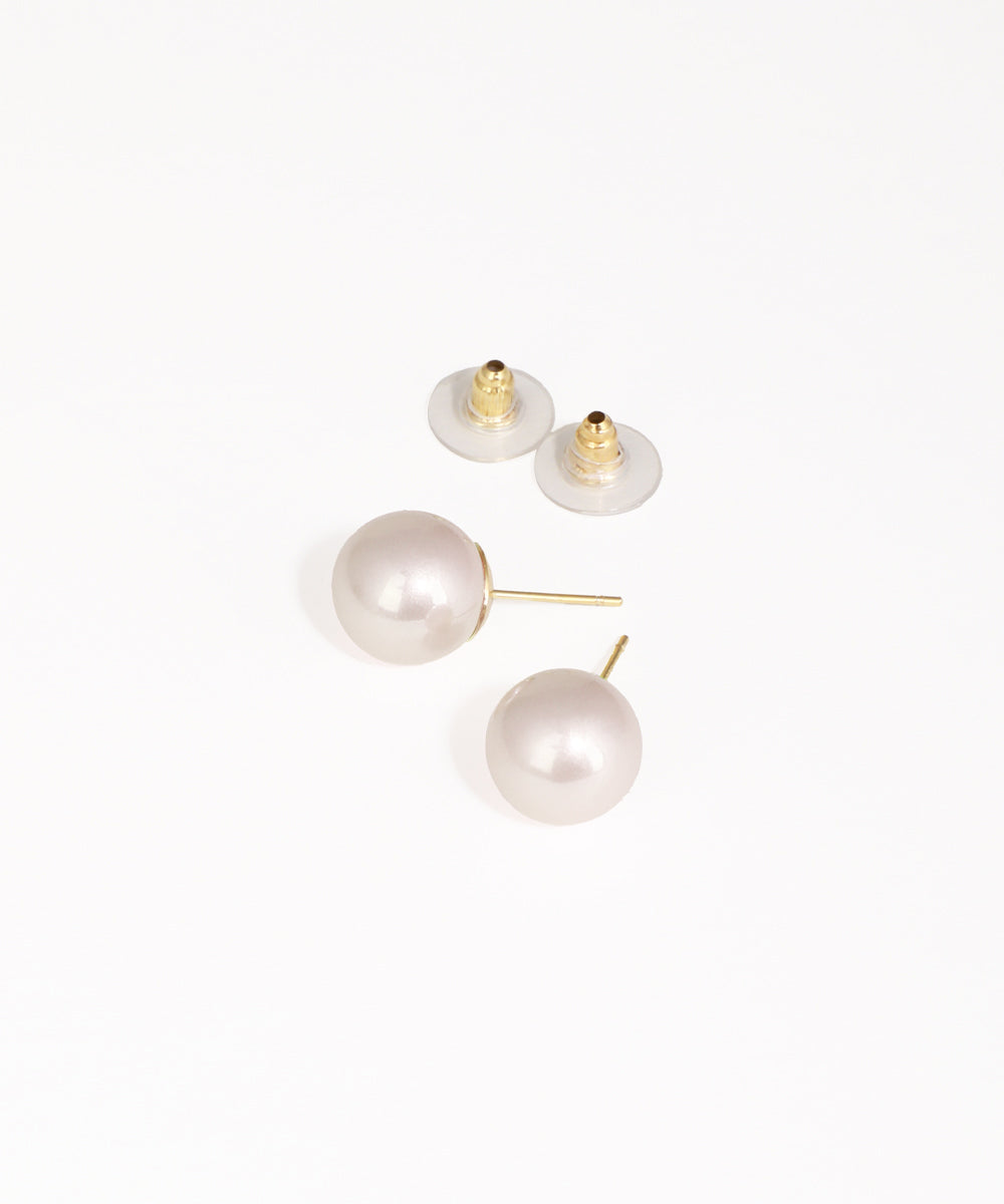 Pearl earrings with gold posts on a white background