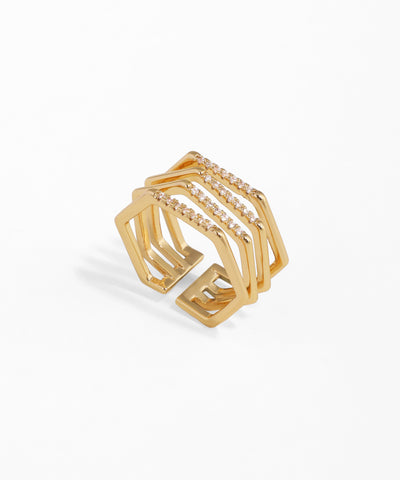 Gold-tone wide band geometric ring with three lines of clear cubic zirconia stones and an open design.
