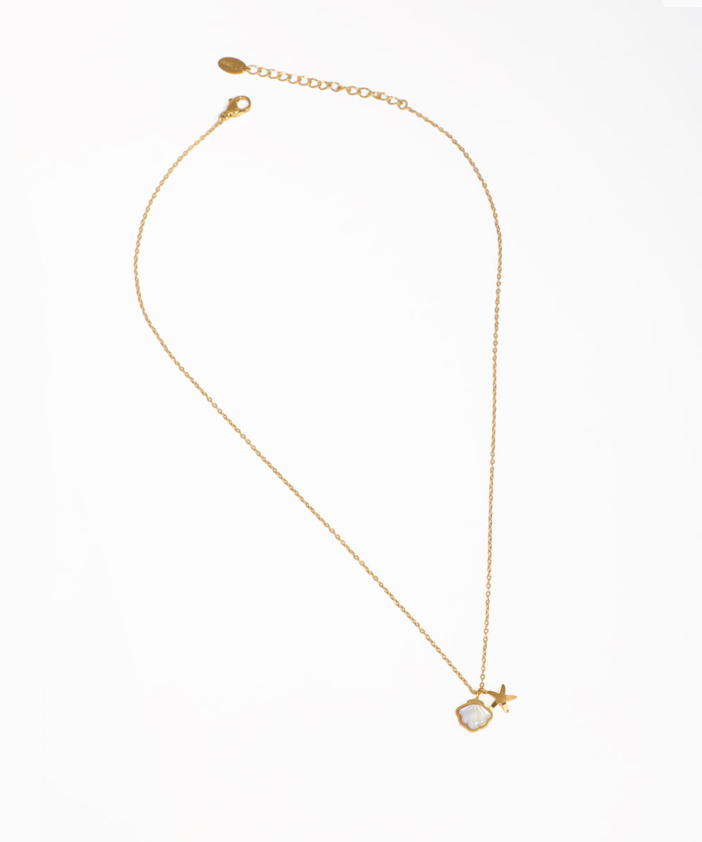 Gold-tone necklace with iridescent shell and small star charm