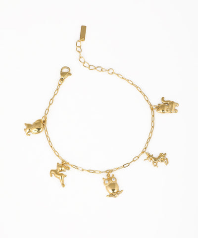 Gold-tone charm bracelet with various animal figures, including an owl with clear stones and a unicorn.