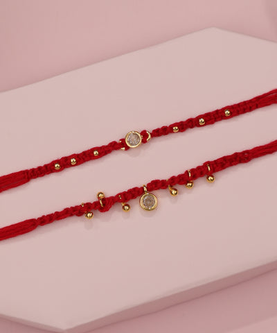 Gold-tone Rakhi set with red thread and clear CZ stones