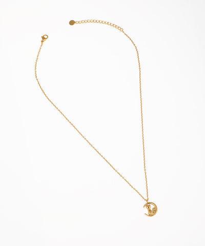 Gold-tone necklace with a crescent moon and cat pendant, featuring a small clear stone.