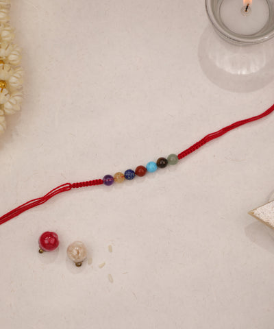 Red thread Rakhi with colorful round glass beads