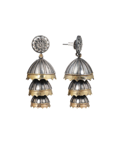 Oxidised silver-tone and gold-tone tiered jhumka earrings with floral stud design.