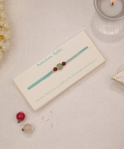 Green and red stone bead thread Rakhi with Om symbol design