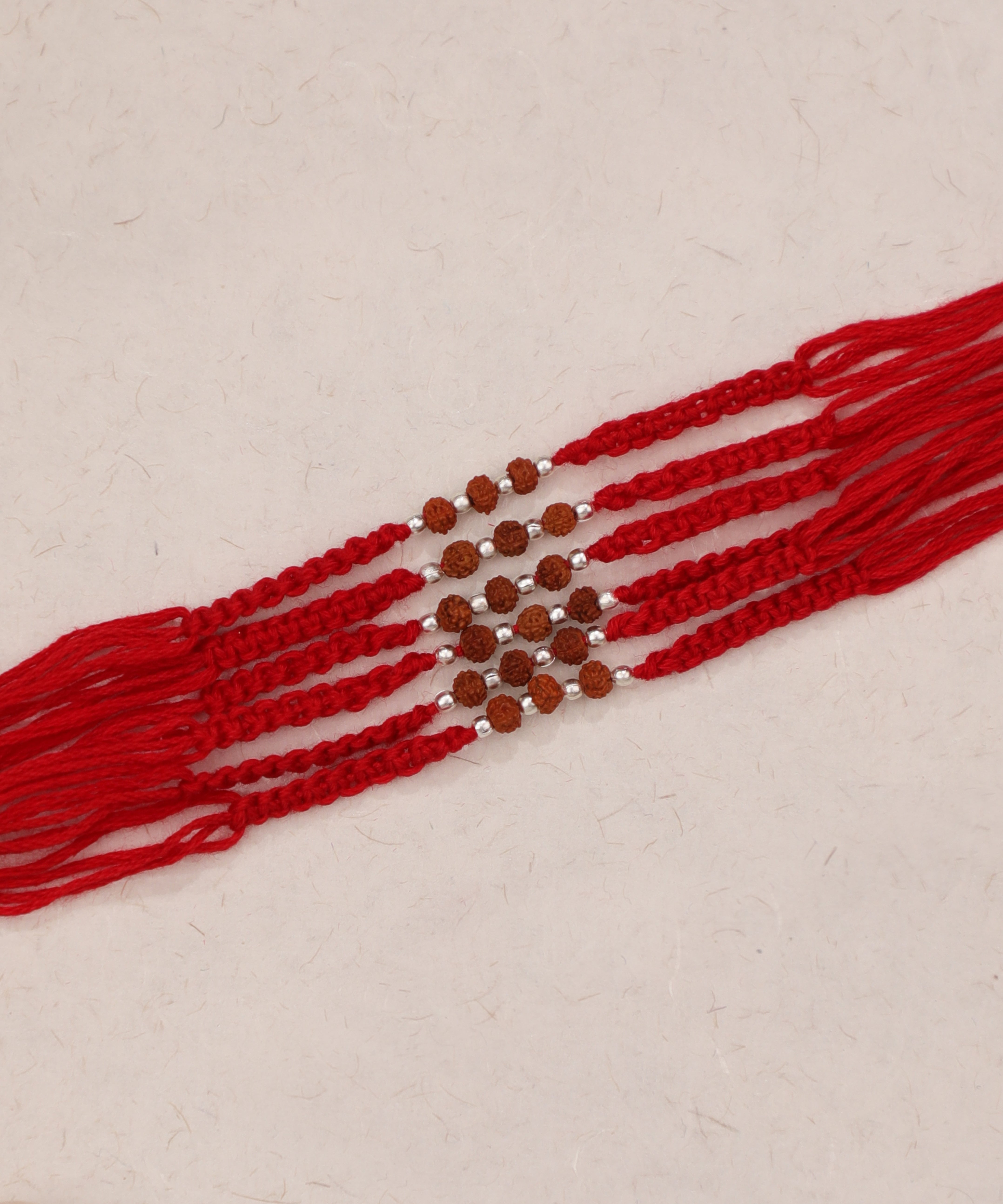 Red thread Rakhi set with Rudraksha and silver-tone beads