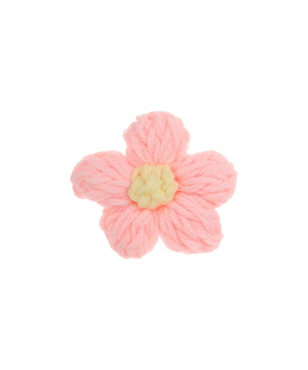 Pink knitted hair clip with yellow flower center
