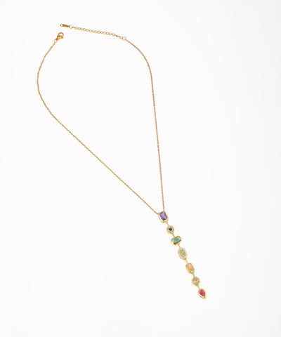 Gold-tone necklace with a long lariat drop featuring multiple colorful stones and clear accent crystals.