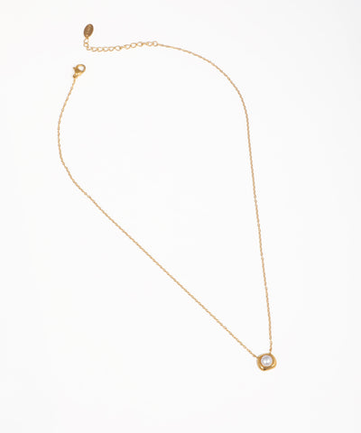 Gold-tone necklace with delicate chain and framed faux pearl orb pendant