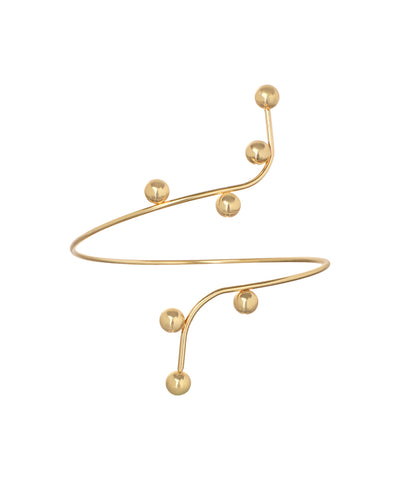 Gold-tone arm cuff with winding sculptural design and polished spherical accents