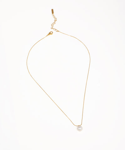 Gold-tone necklace with a fine chain and a single white round faux pearl drop