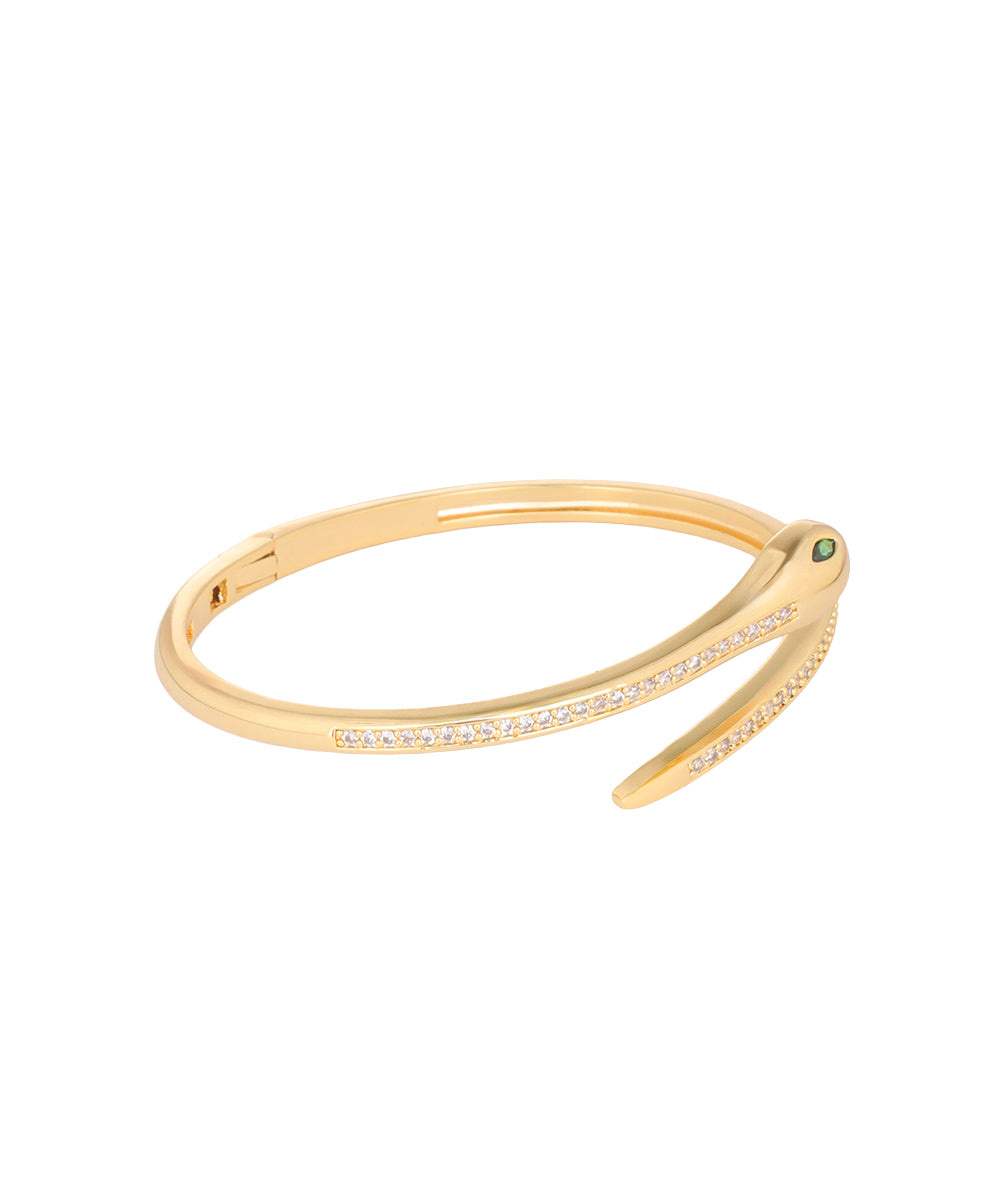 A gold hinged bangle bracelet with a pavé diamond band and a small green gemstone accent, shown on a plain white background.