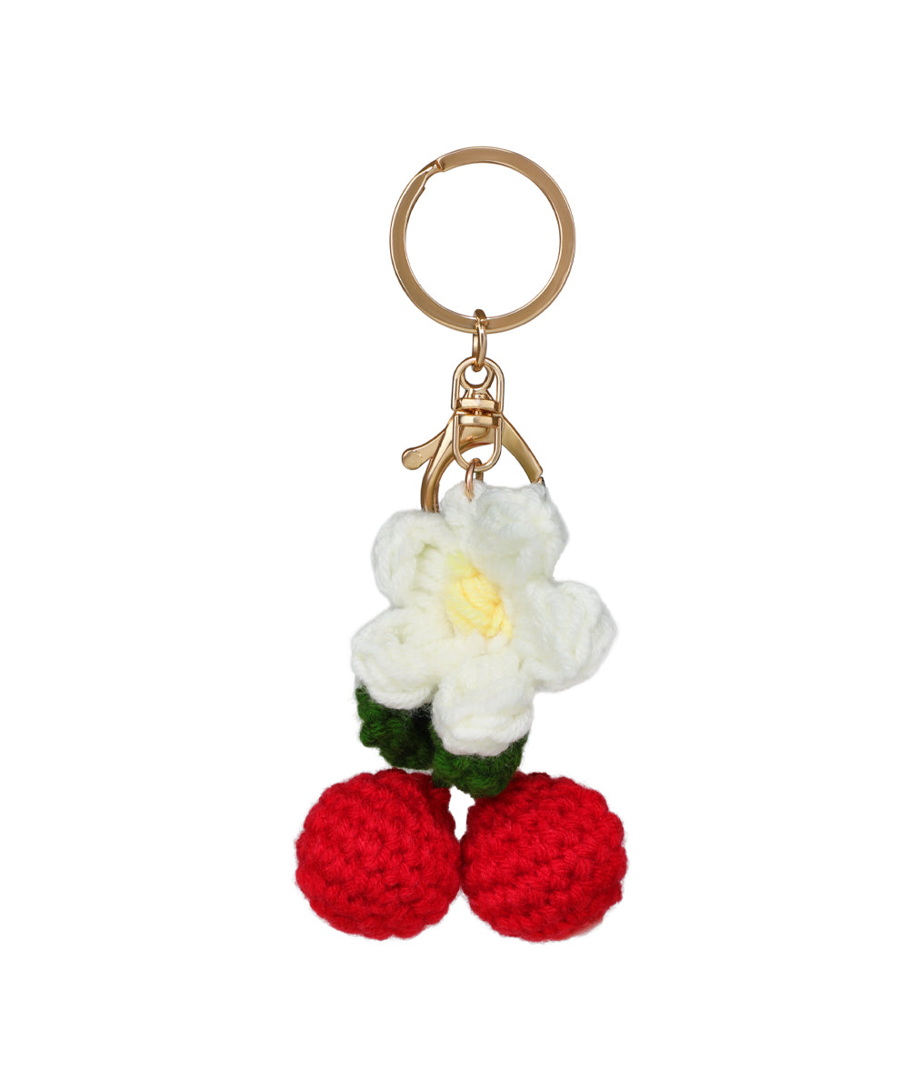 Gold-tone keychain with white crochet flower and red crochet cherry details